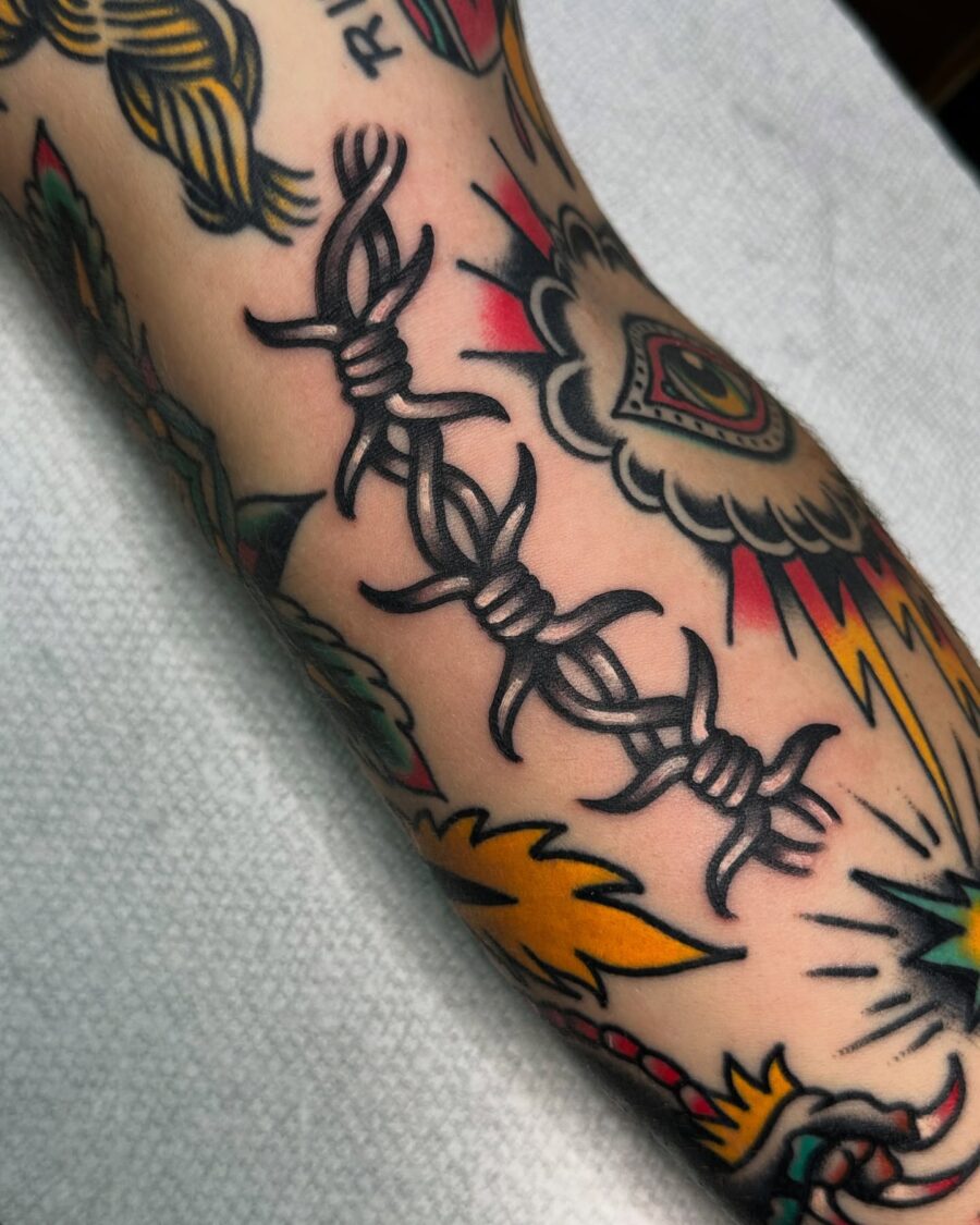 Bold barbed wire tattoo symbolizing resilience