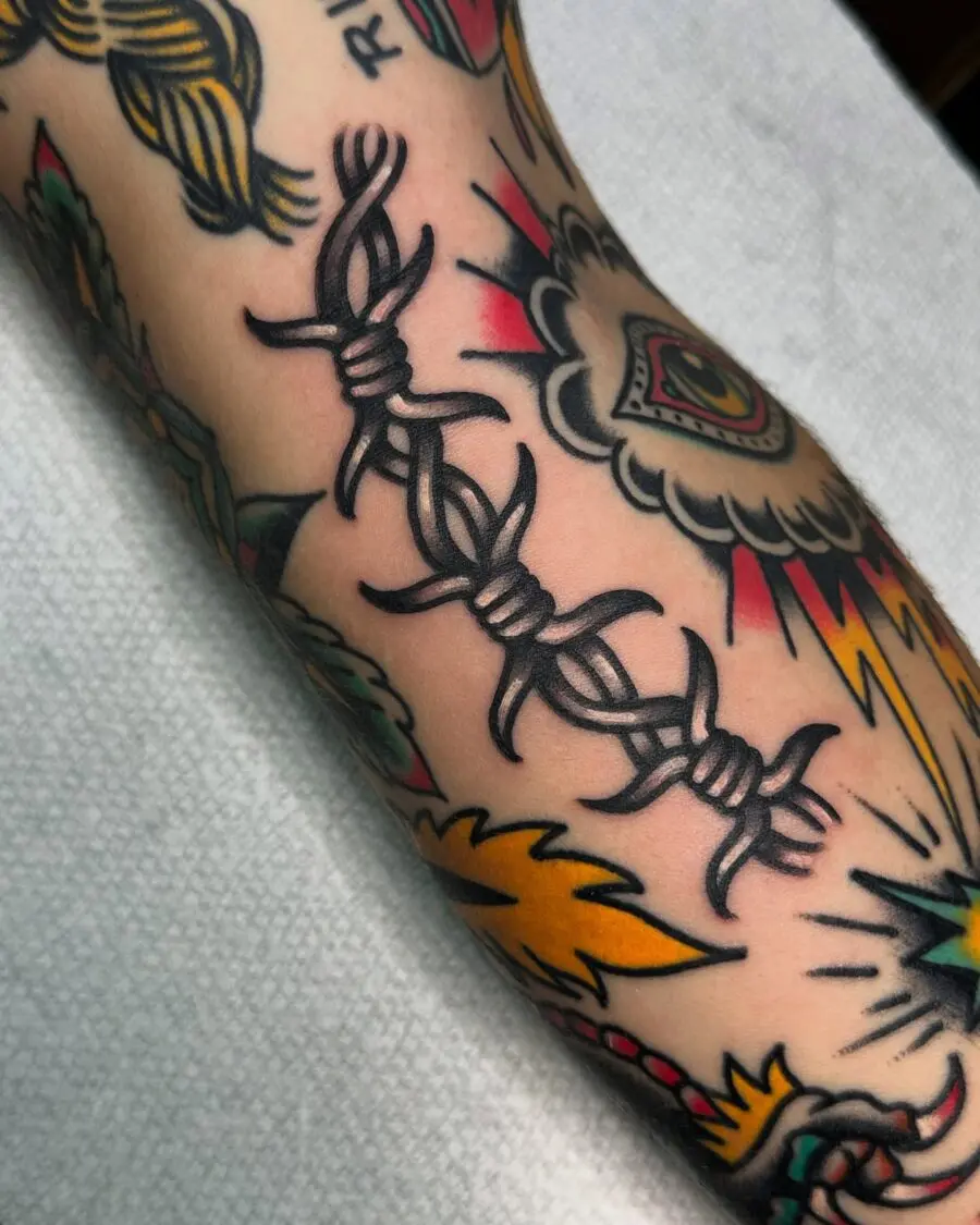 Bold barbed wire tattoo symbolizing resilience