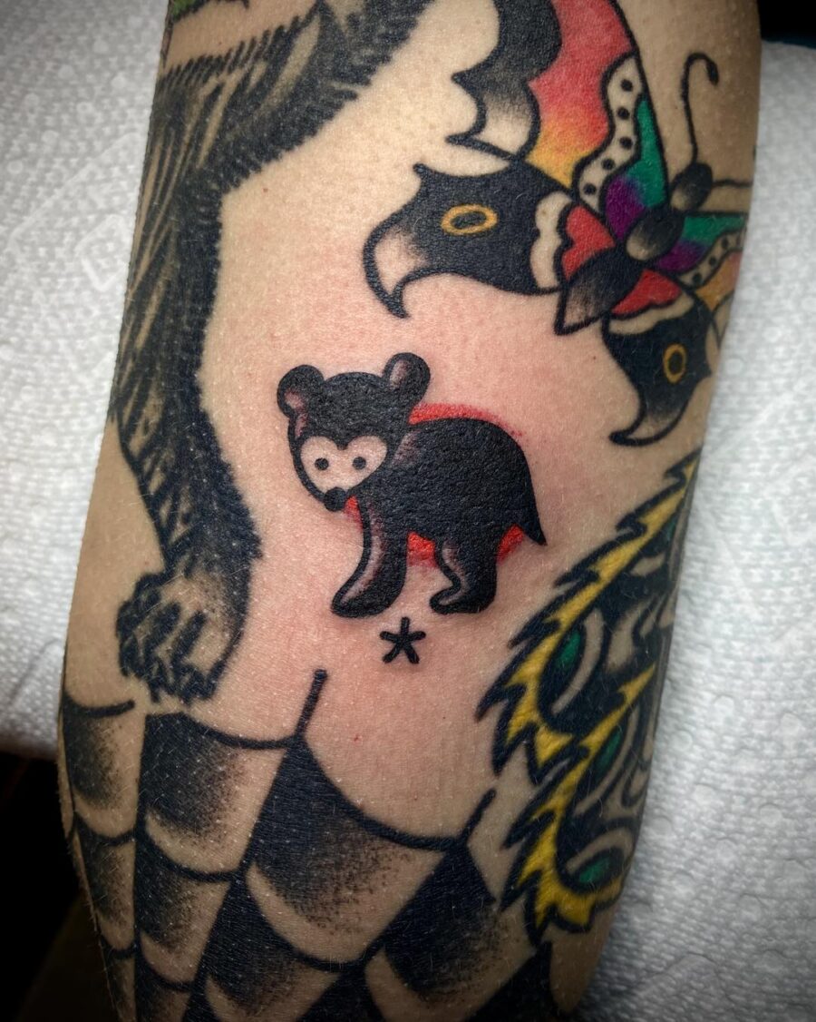 Playful bear tattoo in Americana style
