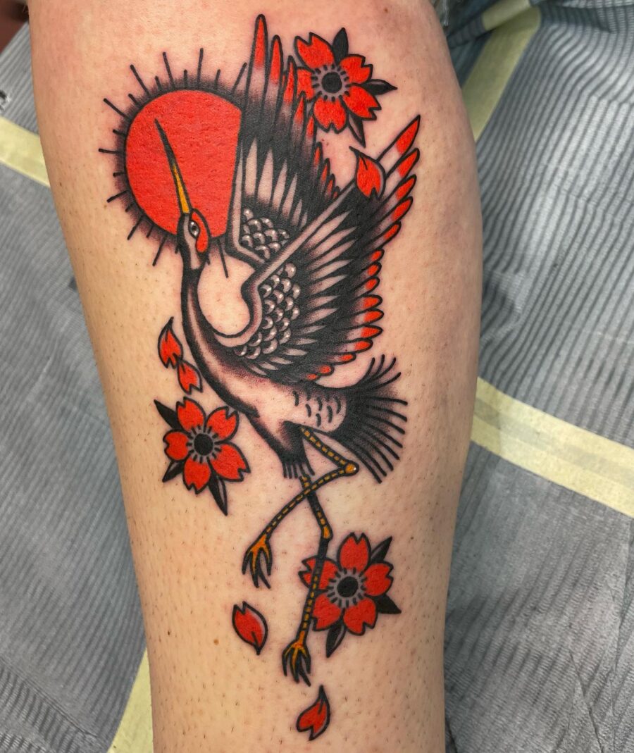 Vibrant crane tattoo with floral elements