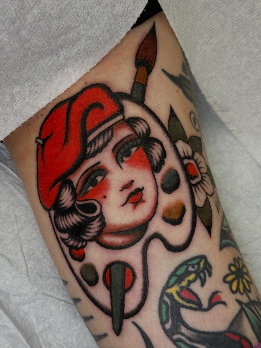 Colorful palette girl tattoo showcasing artistic spirit
