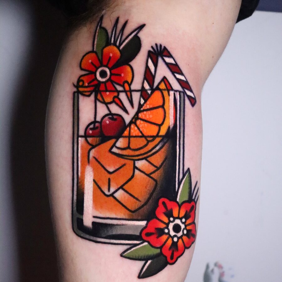 Vibrant cocktail tattoo with floral elements