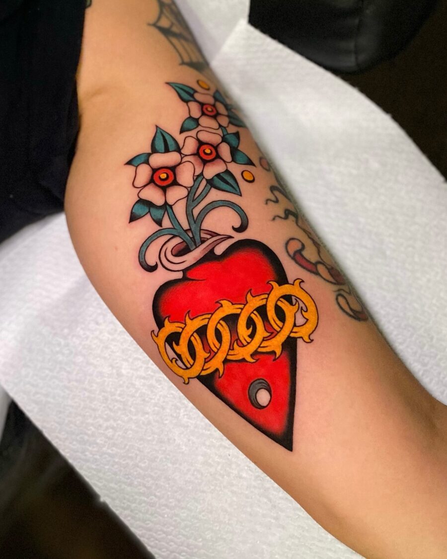 Vibrant flower heart tattoo with chain design