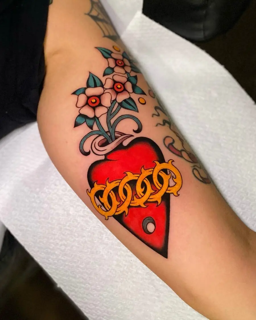 Vibrant flower heart tattoo with chain design