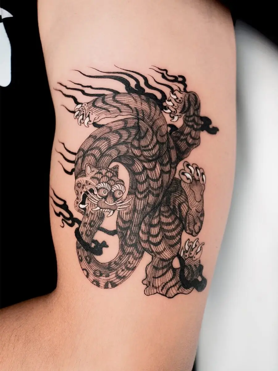 Intricate black ink dragon and tiger tattoo