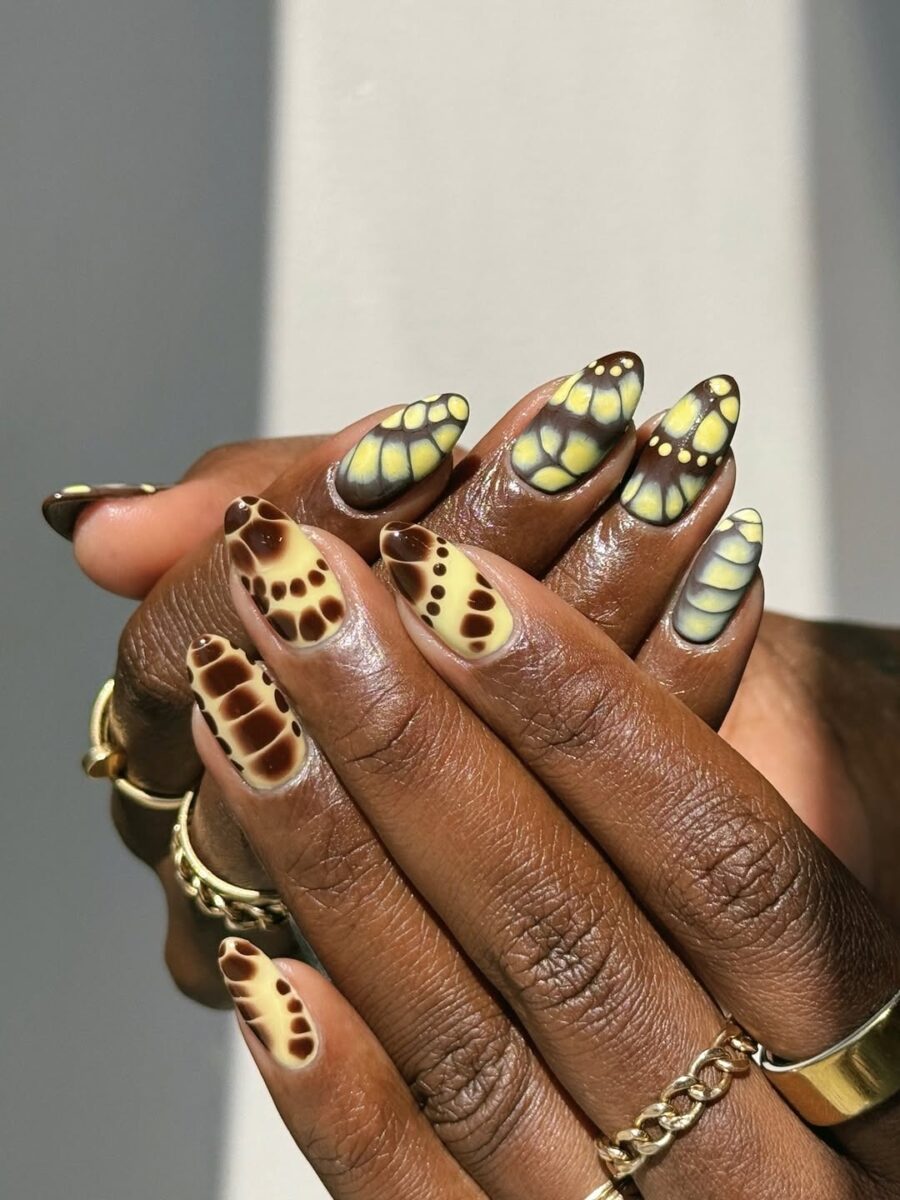 Stylish animal print nails with butterfly accents