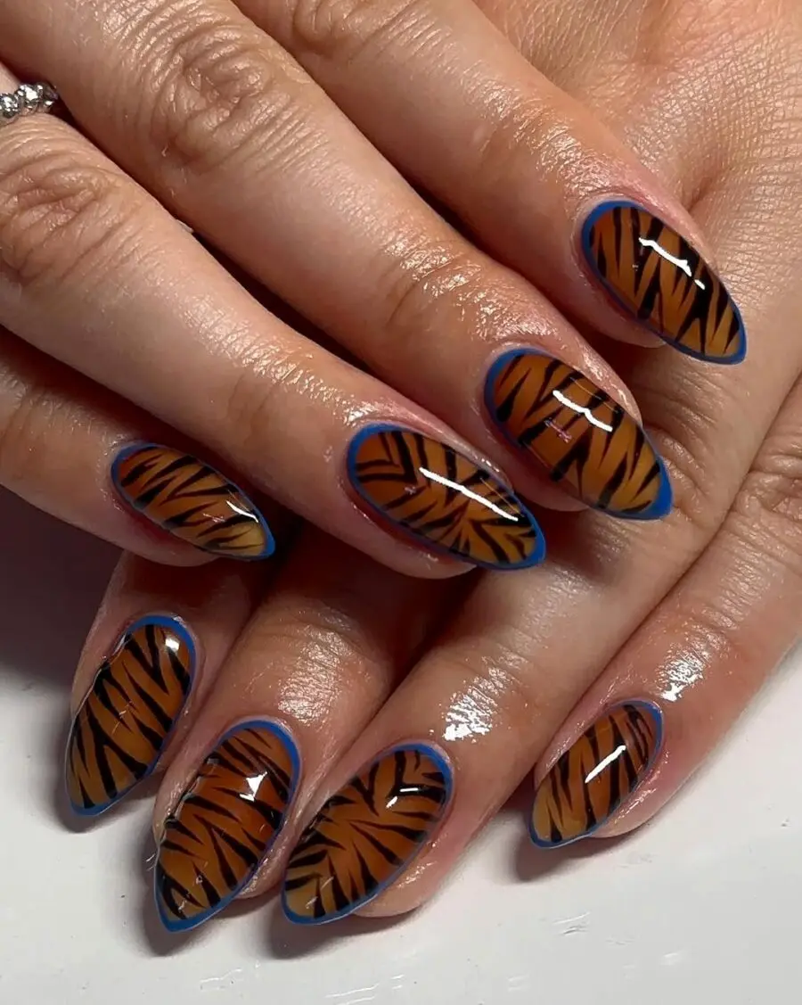 Bold tiger stripes on glossy almond nails