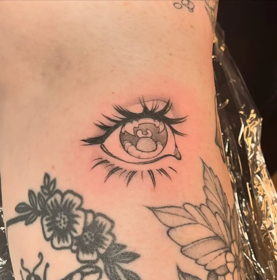 Realistic anime eye tattoo with floral elements