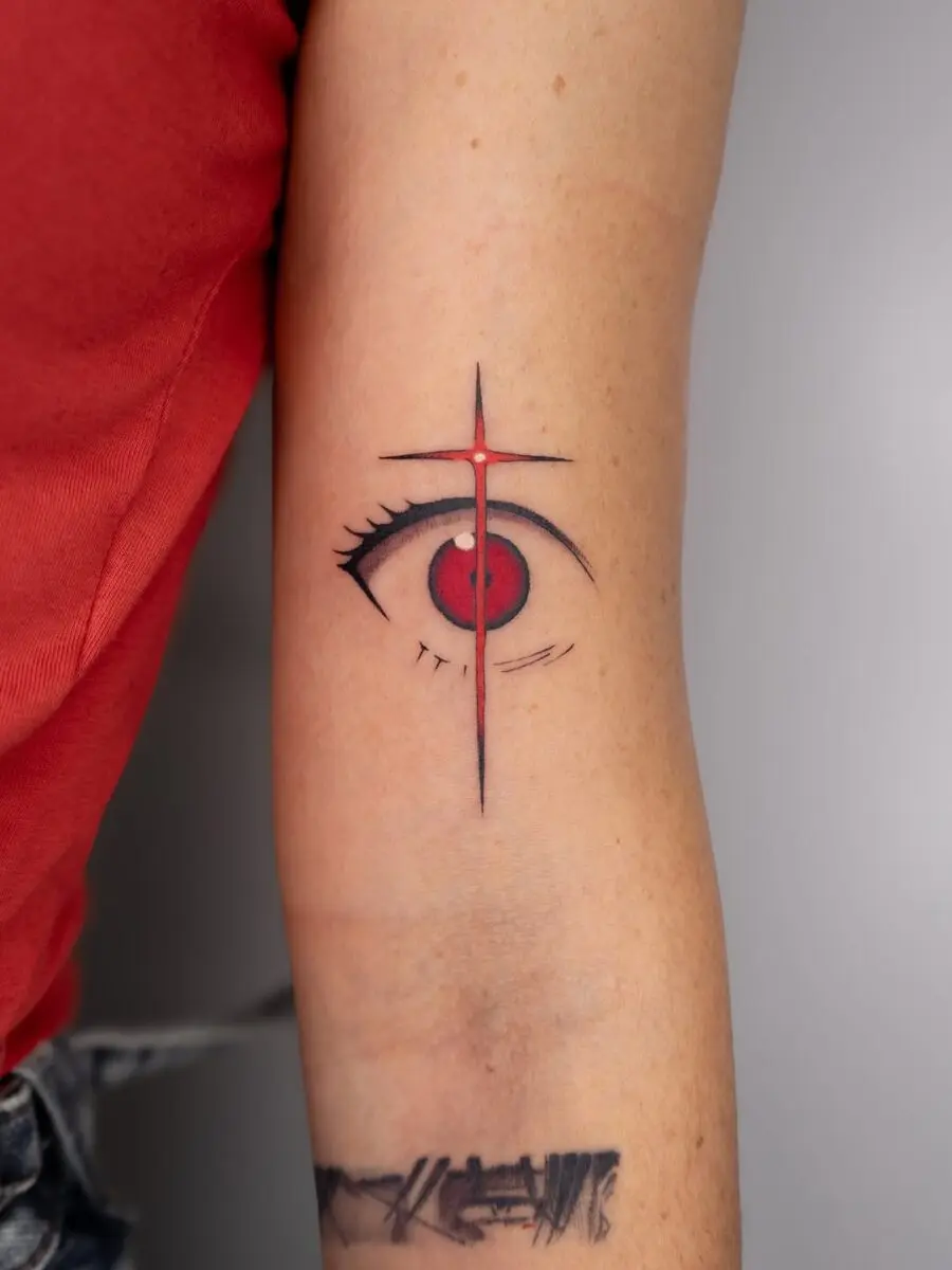 Striking red eye tattoo with cross design