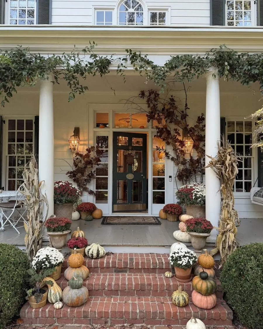 Charming autumn porch with pumpkins and flowers