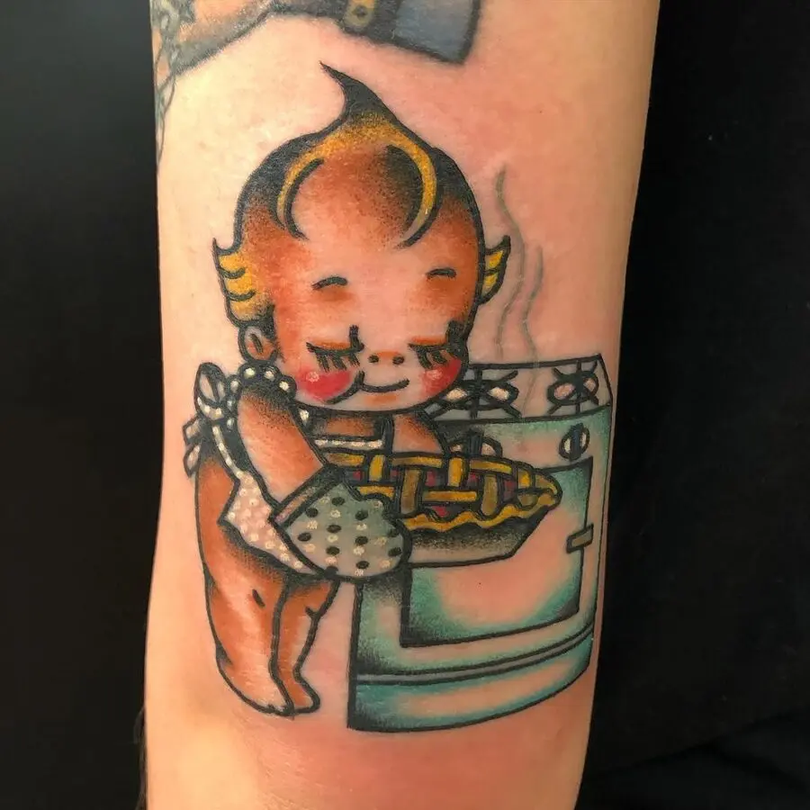 Charming pie-baking baby tattoo design