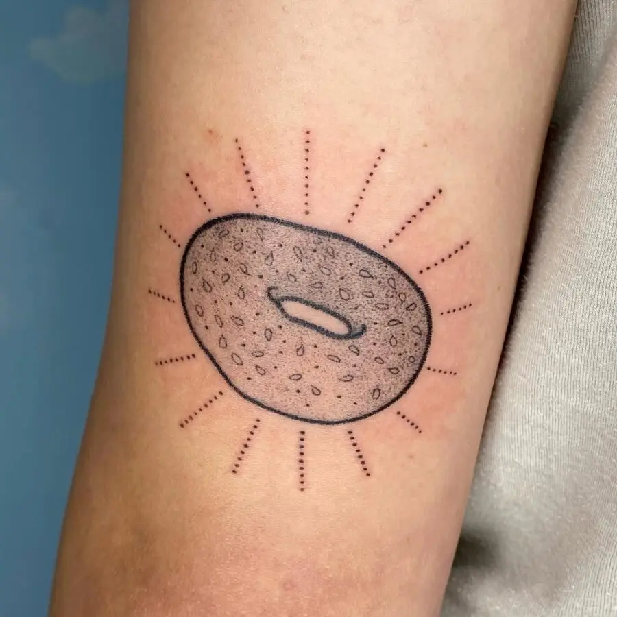Minimalistic bagel tattoo radiating sunshine vibes