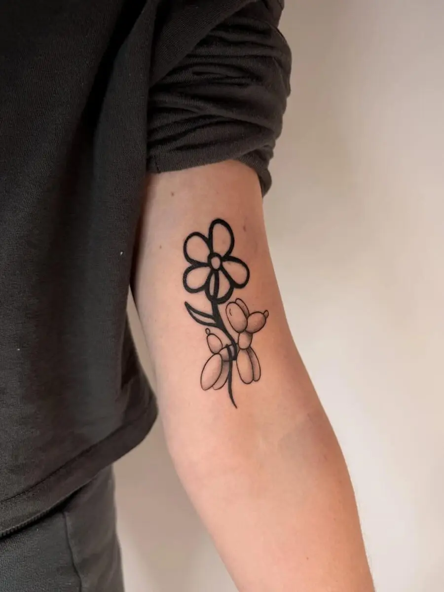 Charming balloon dog tattoo with floral accents