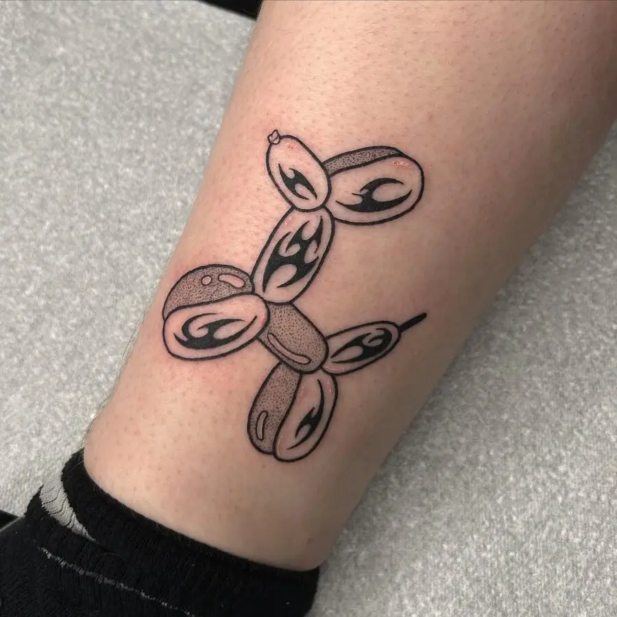 Charming balloon dog tattoo in black ink