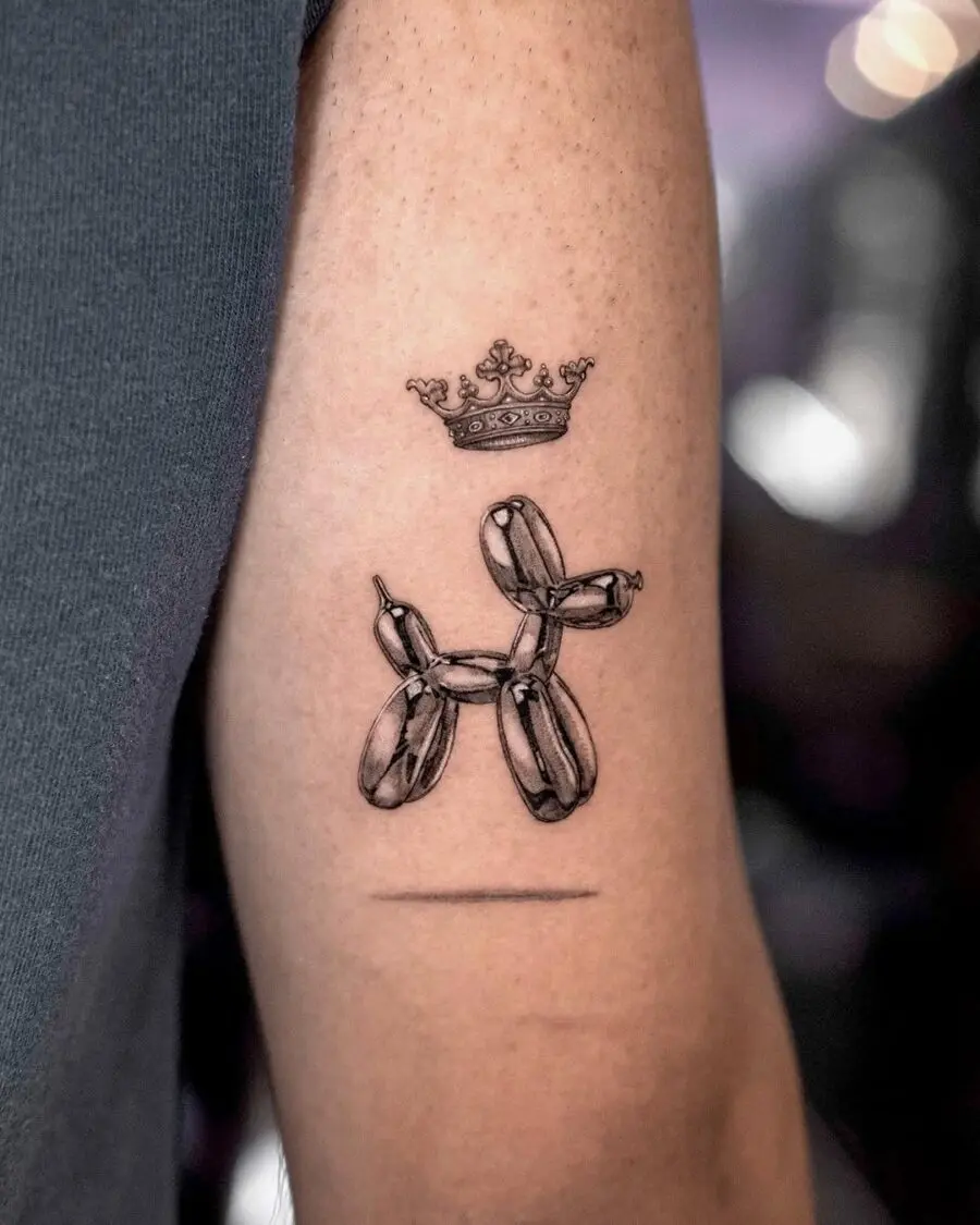 Whimsical balloon dog tattoo with royal crown
