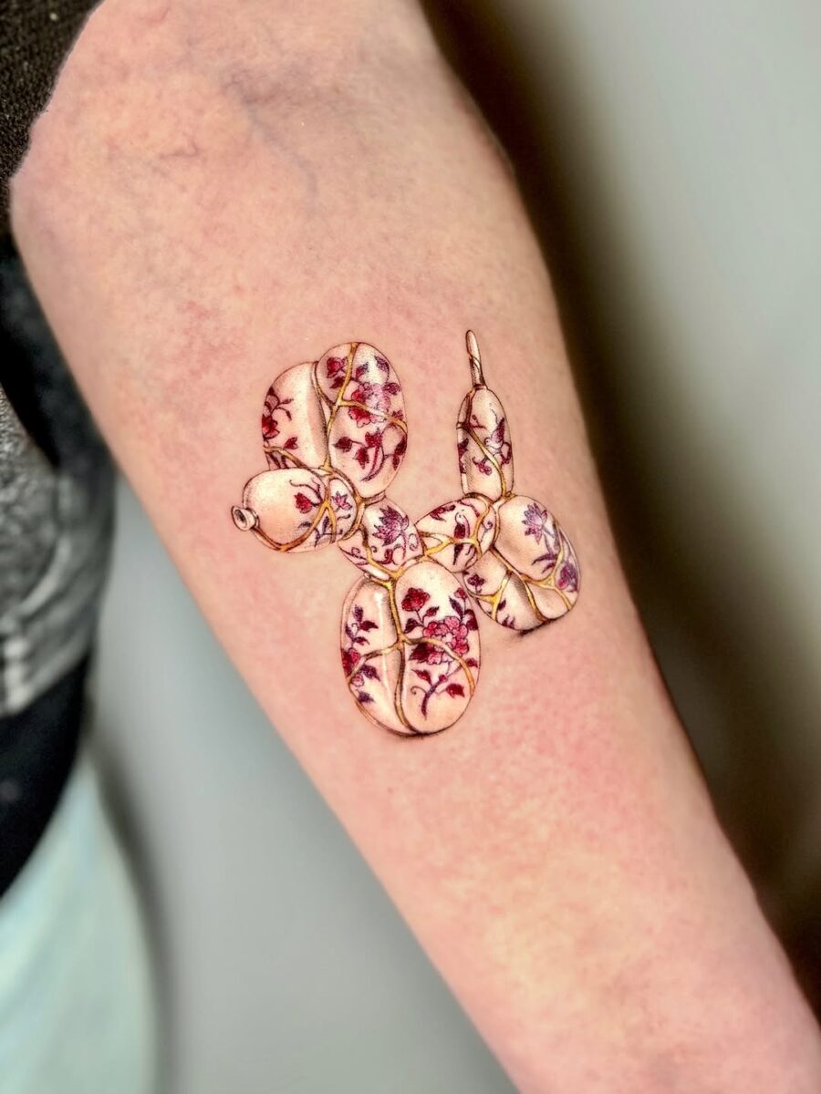 Whimsical Balloon Dog Tattoo with Floral Touch