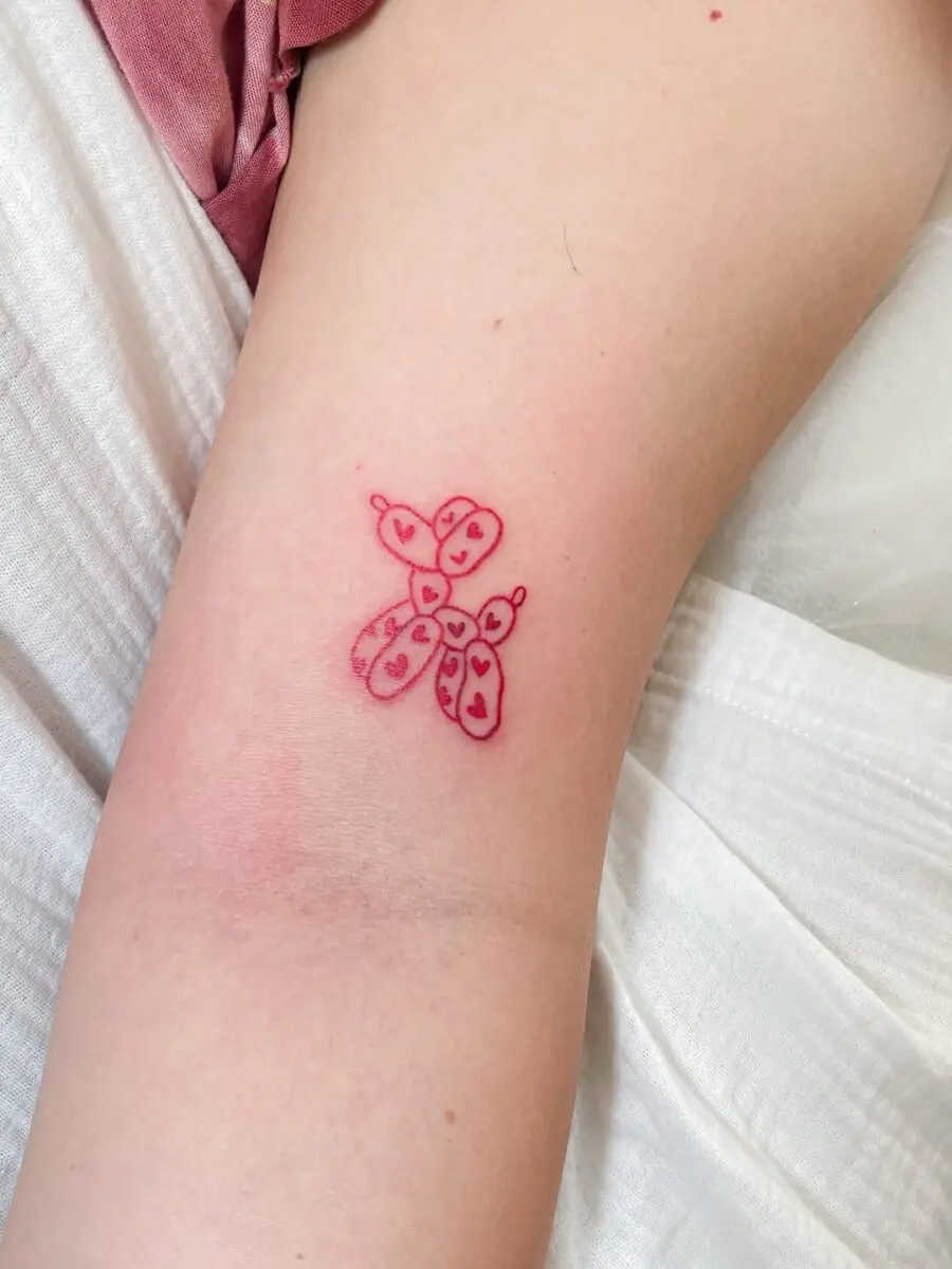Charming pink balloon dog tattoo design