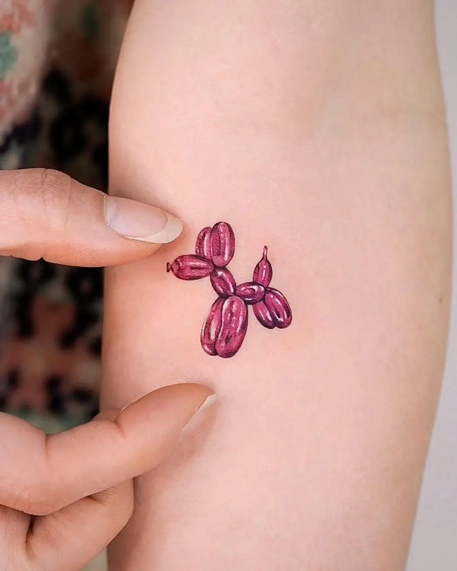 Unique purple balloon dog tattoo design on skin