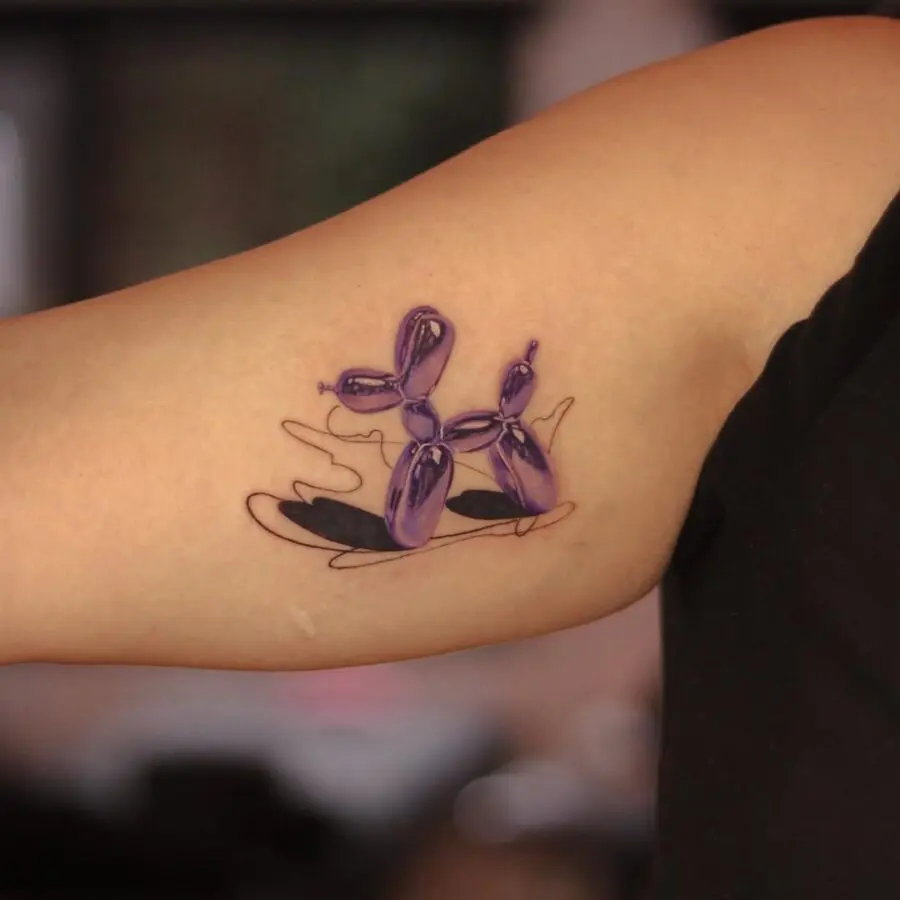 Vibrant purple balloon dog tattoo with artistic flair