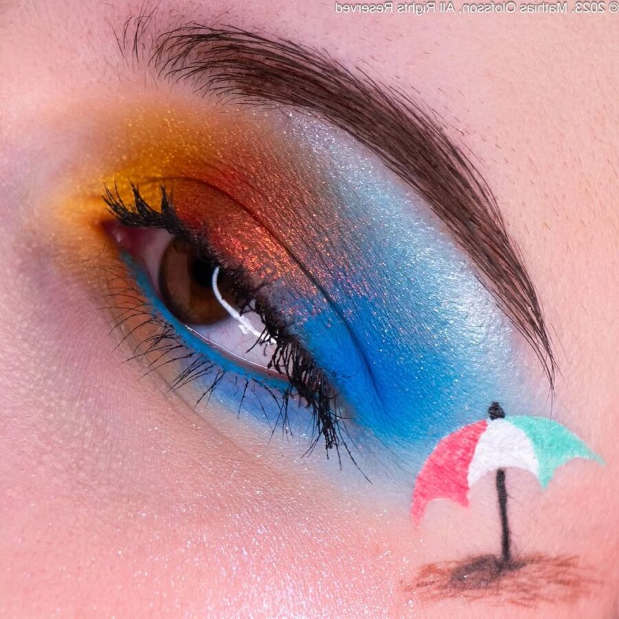 Vibrant beach-inspired eye makeup with umbrella art