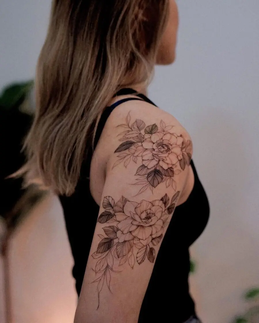 Elegant gardenia tattoo on the upper arm