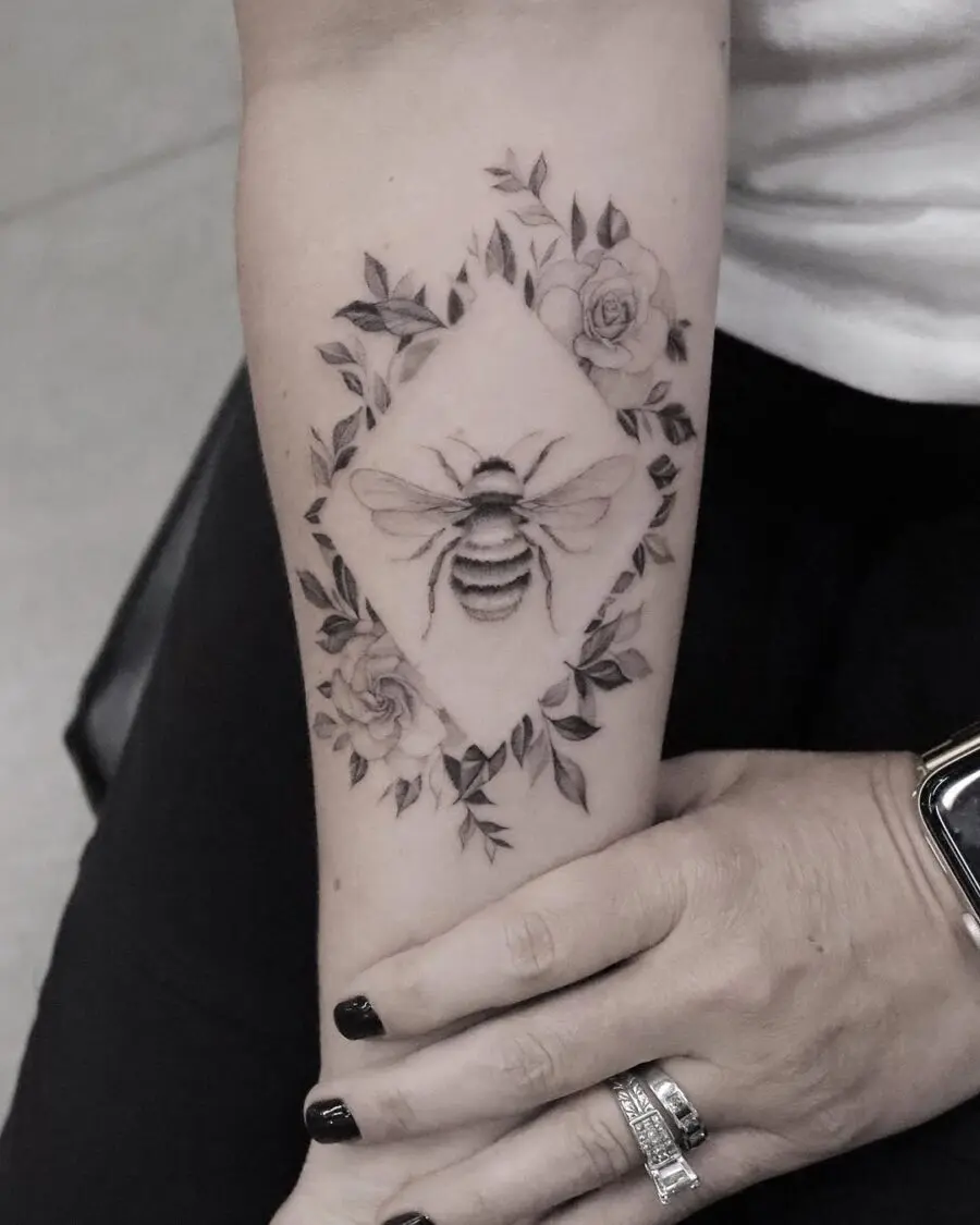 Intricate gardenia and bee tattoo design