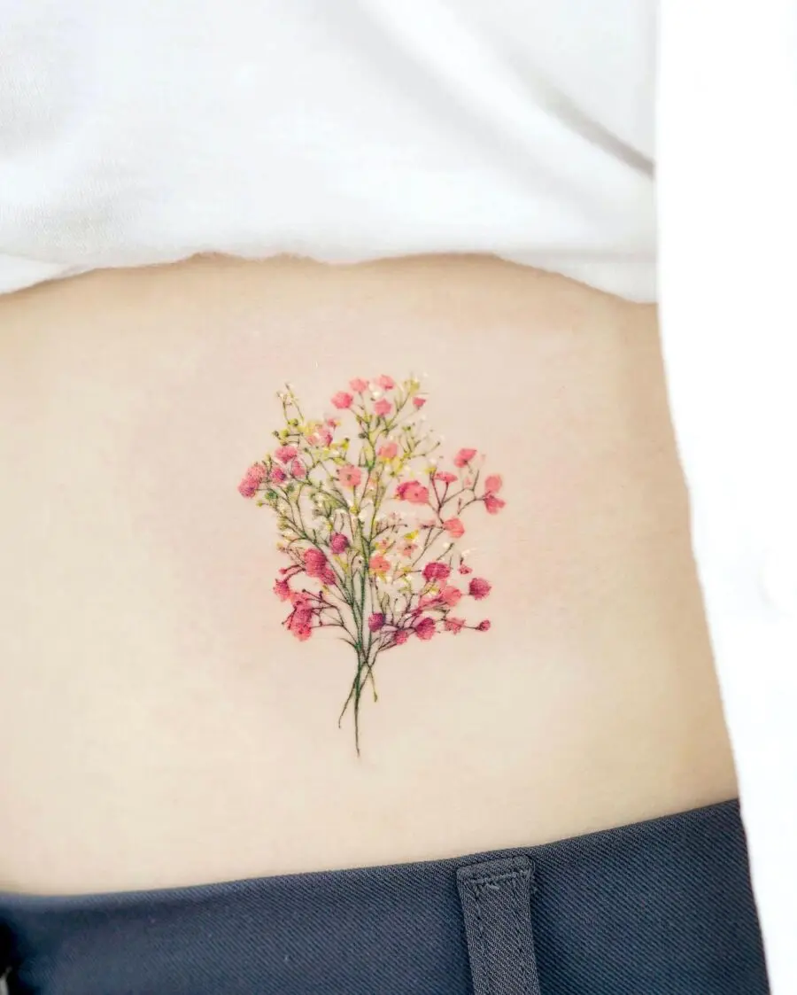 Delicate floral belly tattoo with vibrant colors