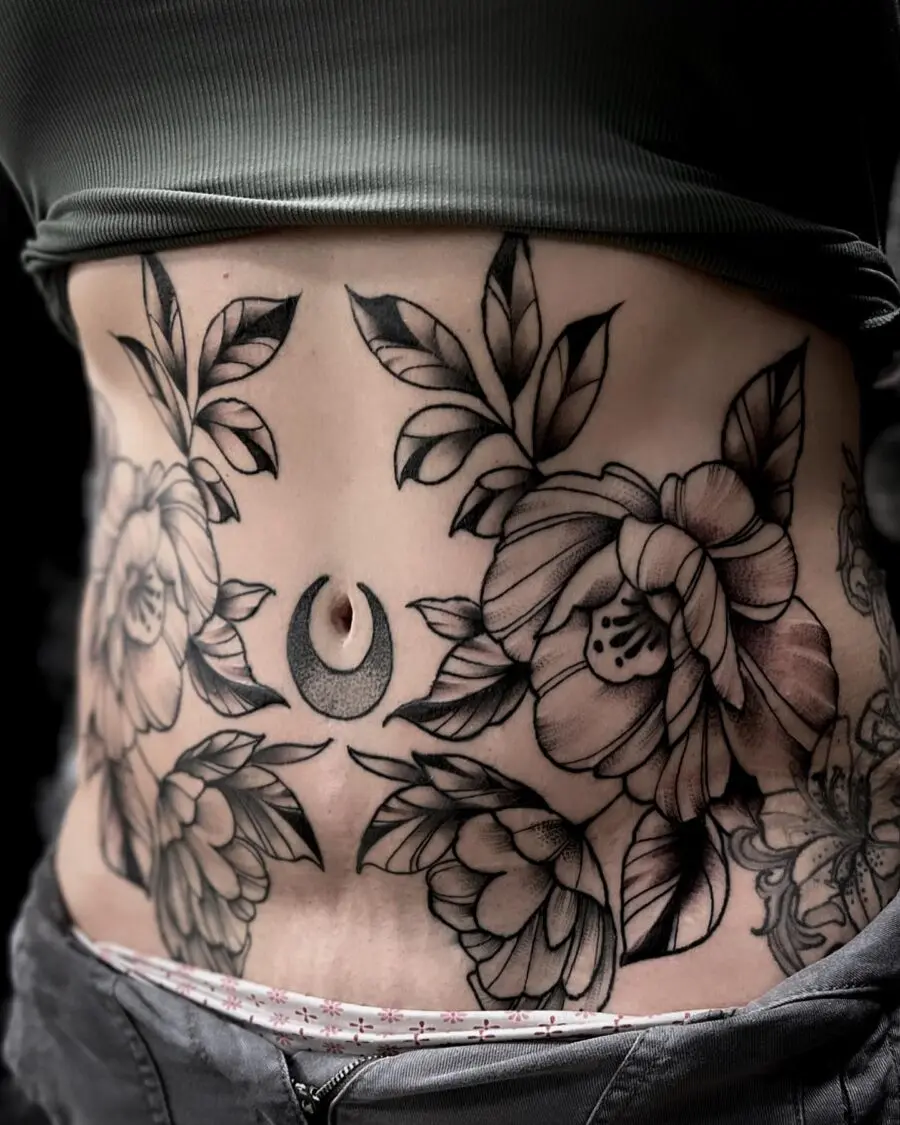 Elegant floral belly tattoo with a crescent moon