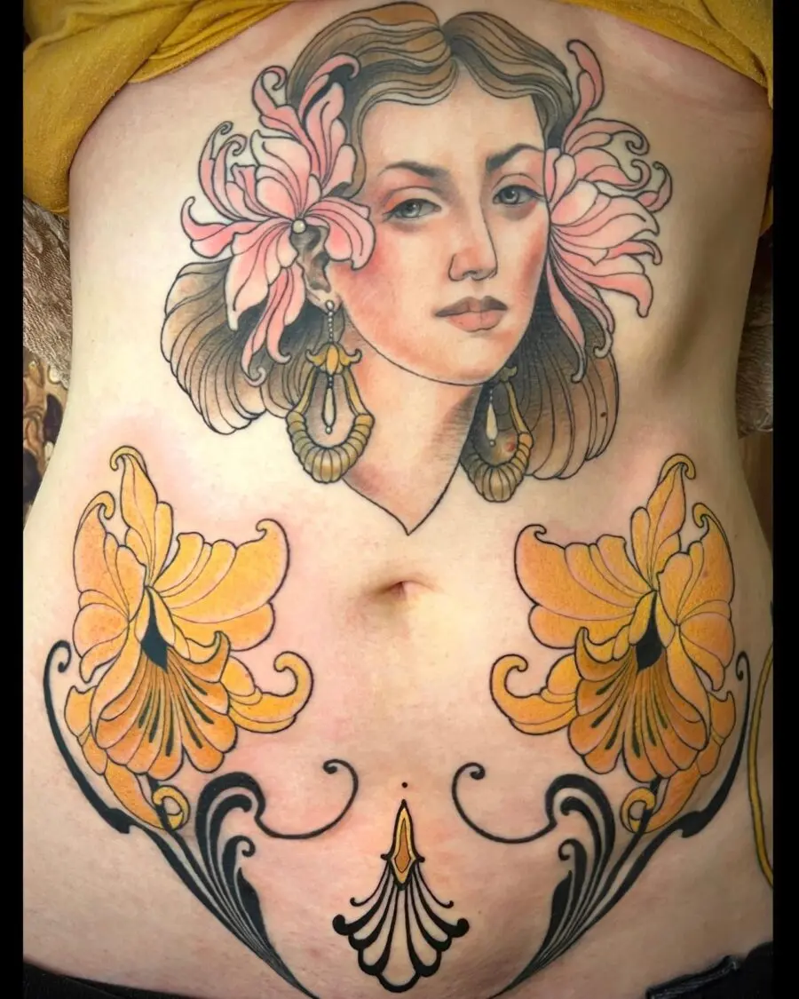 Elegant feminine belly tattoo featuring floral elements