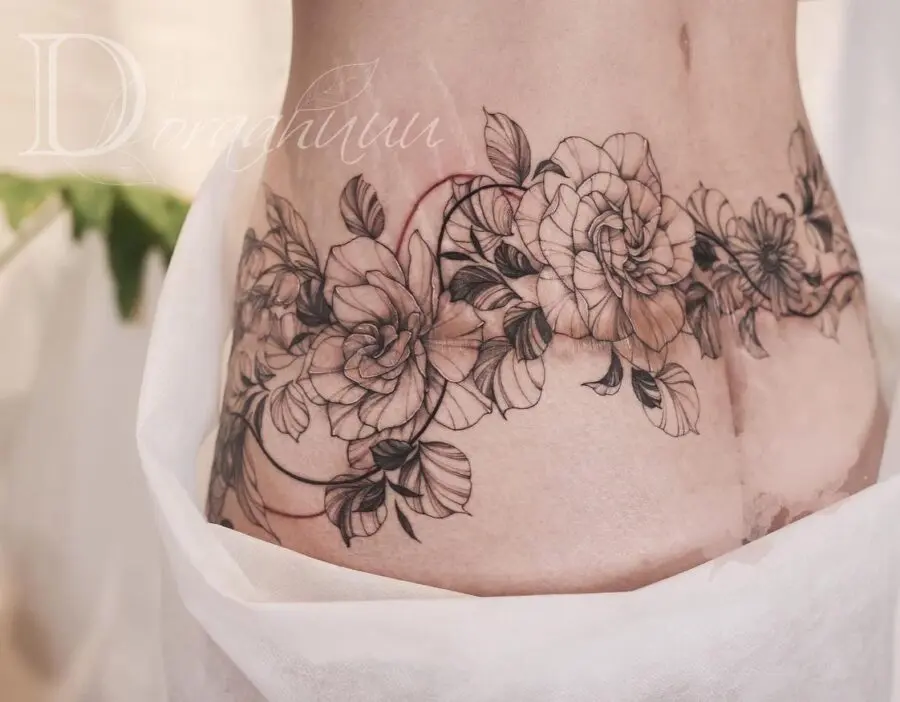 Elegant floral belly tattoo with intricate details