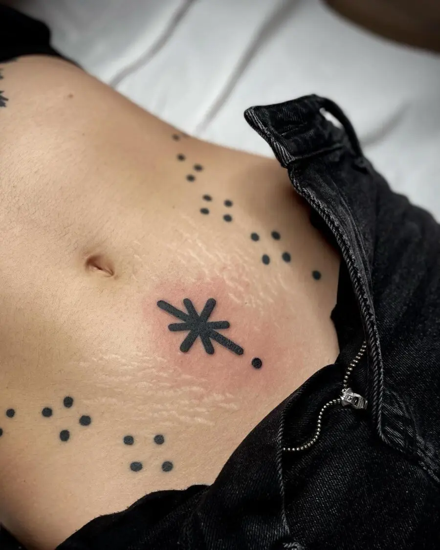 Unique starburst belly tattoo with dot accents