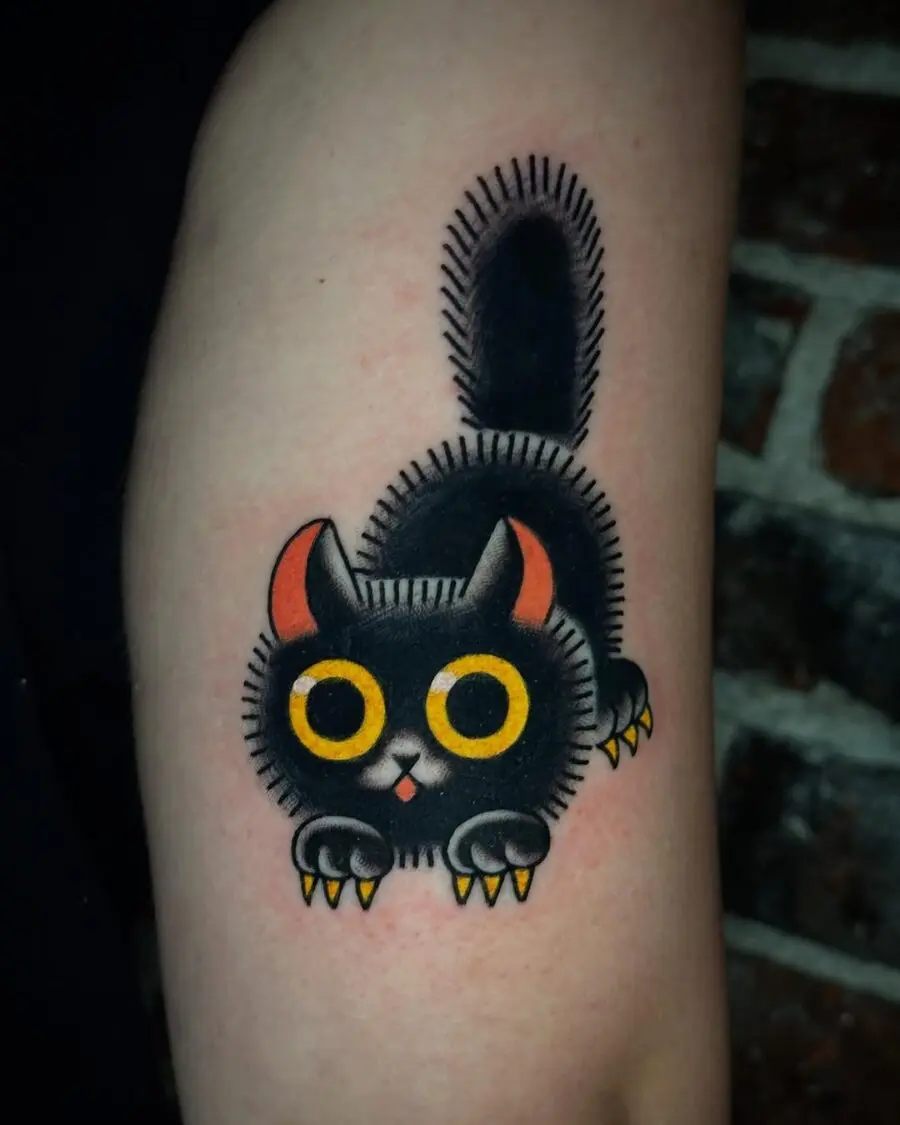 Playful black cat tattoo with vibrant colors