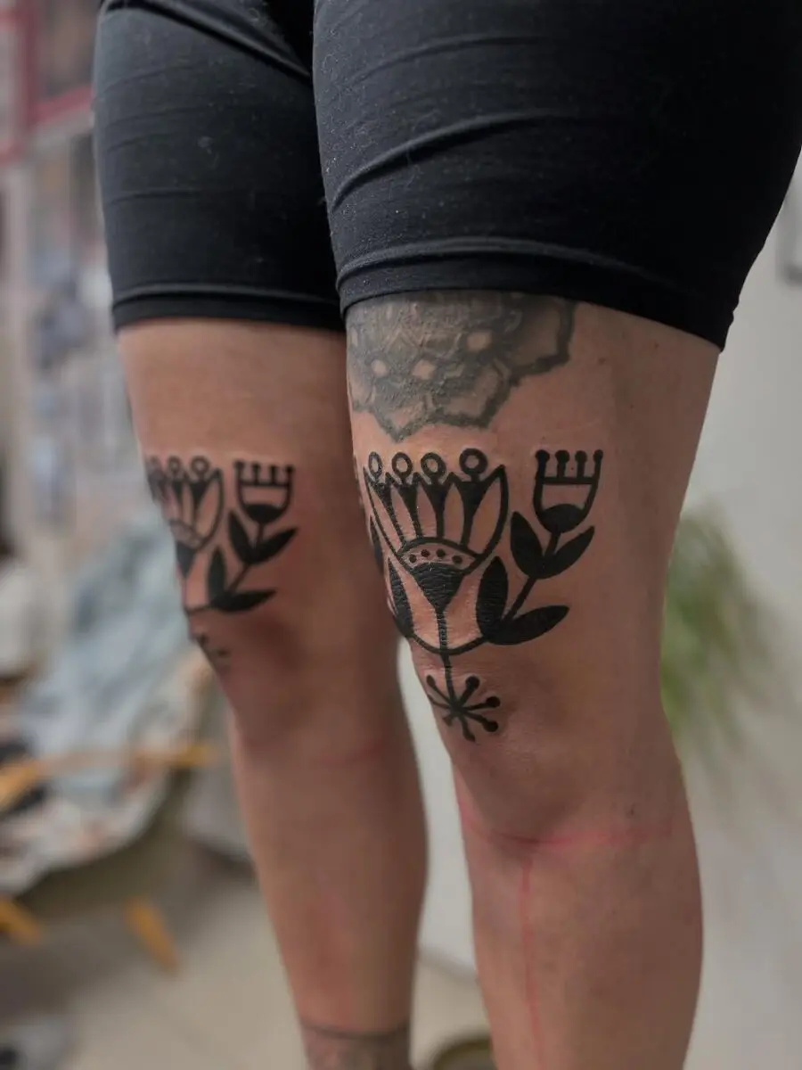 Intricate floral tattoos adorning the thighs