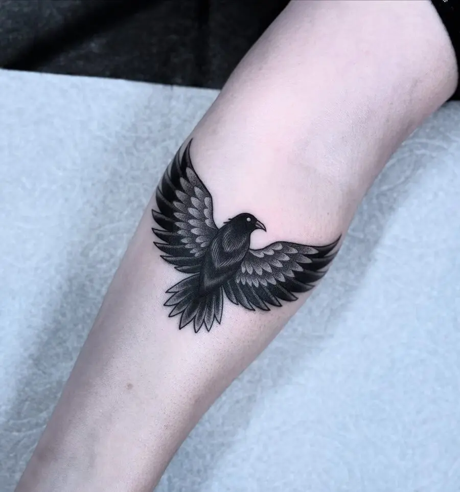 Stunning black raven tattoo in flight