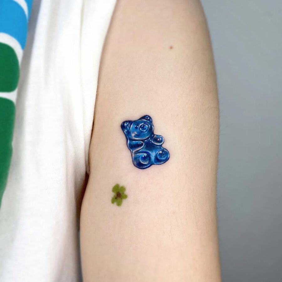 Cute blue gummy bear tattoo on arm