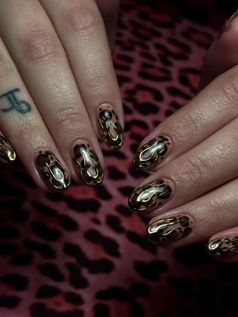 Stylish gold and black animal print nails