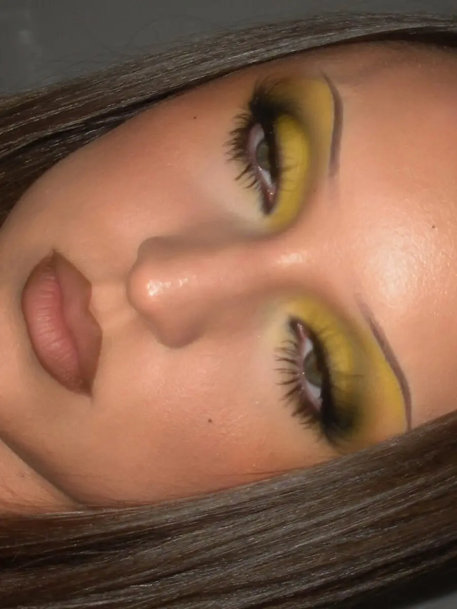 Bright yellow eyeshadow with nude lips