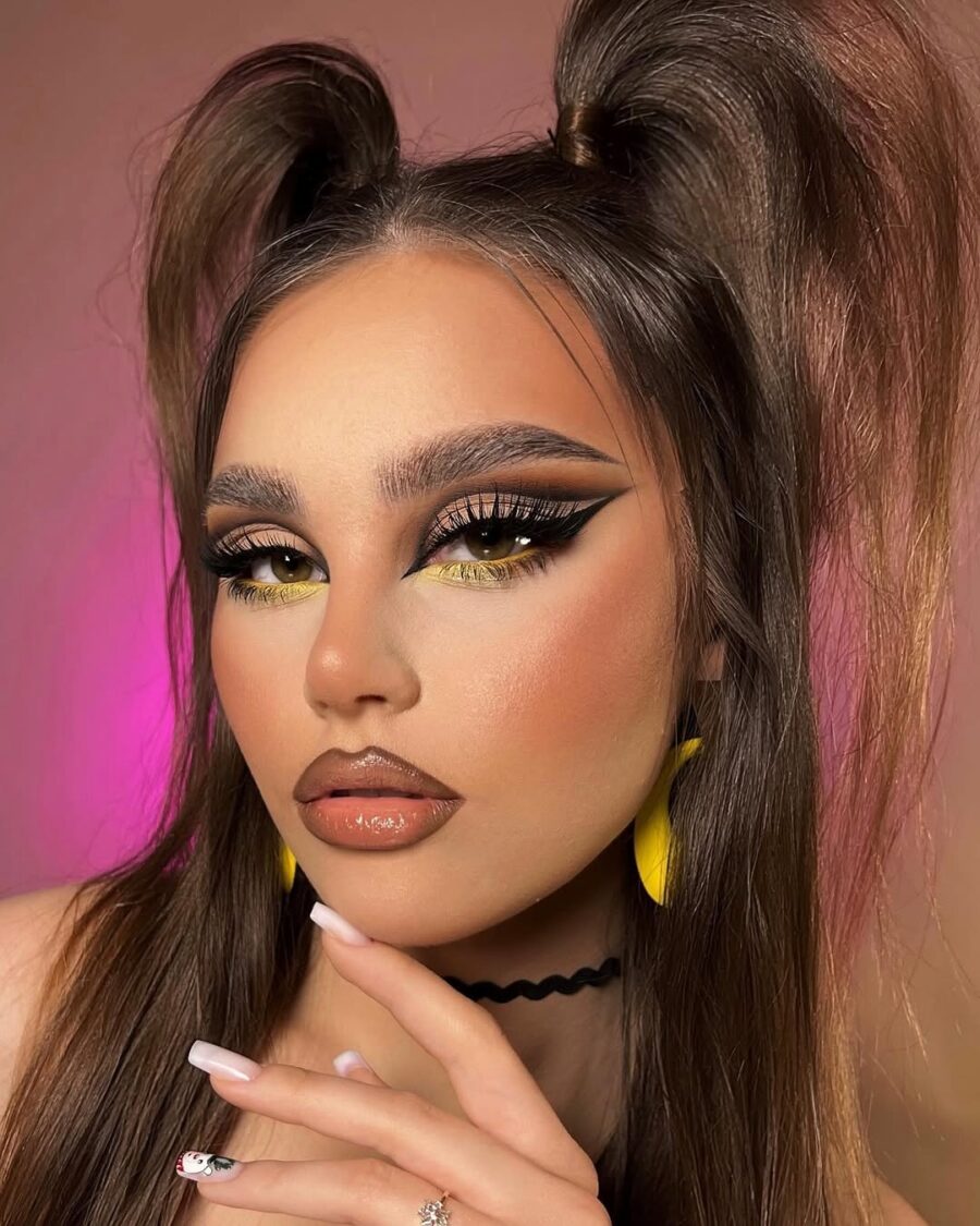 Dramatic yellow makeup with graphic eyeliner