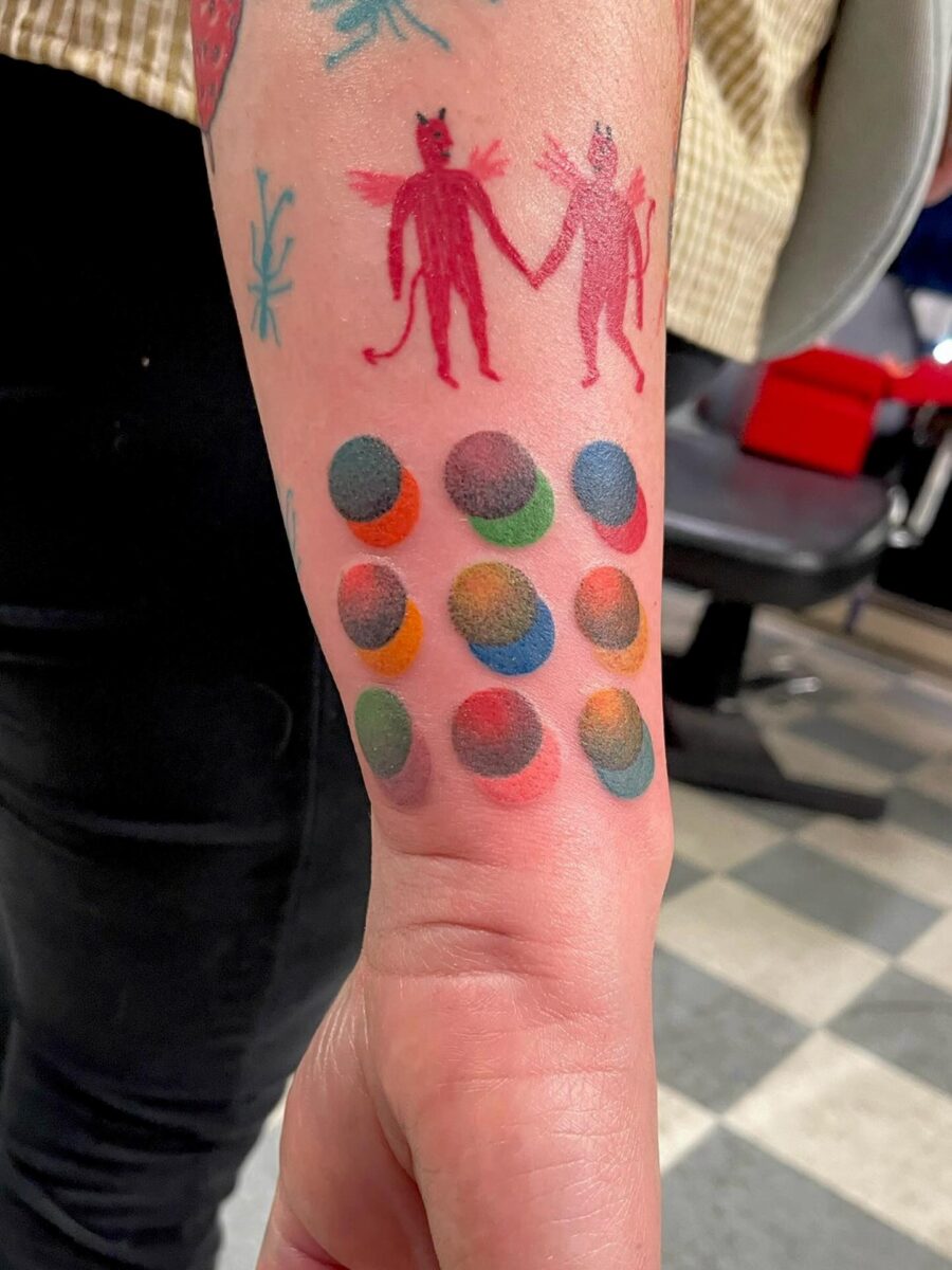 Vibrant tattoos showcasing playful characters and patterns