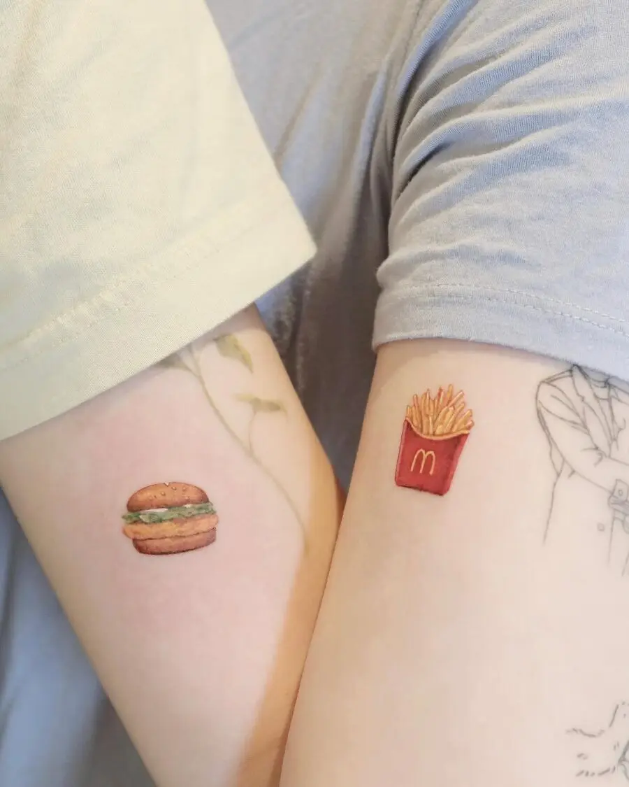 Charming burger and fries arm tattoos