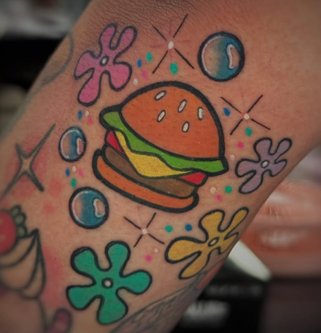 Playful burger tattoo with colorful accents