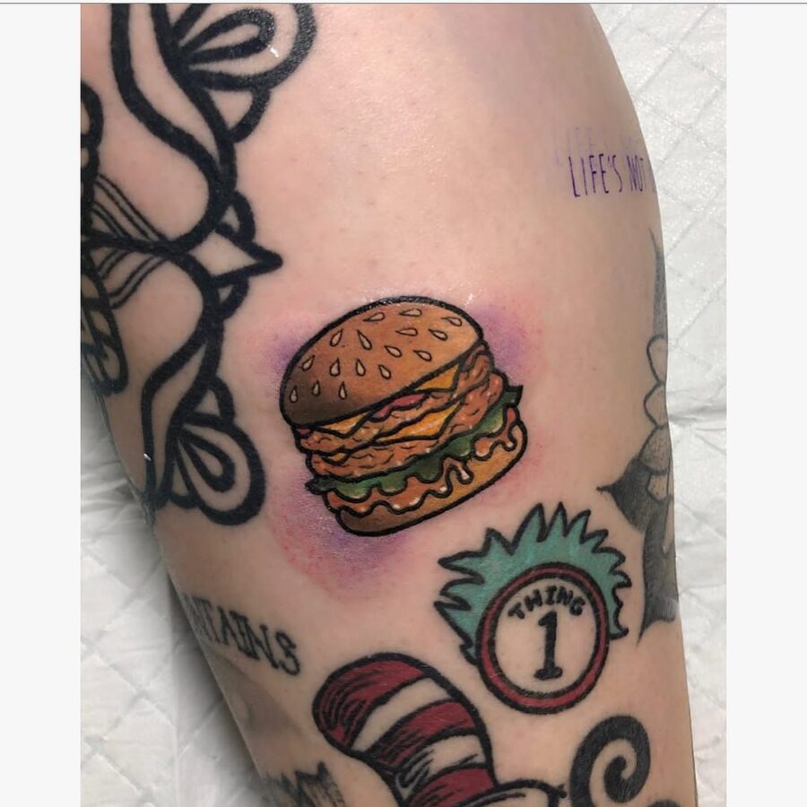 A vibrant burger tattoo with a playful vibe