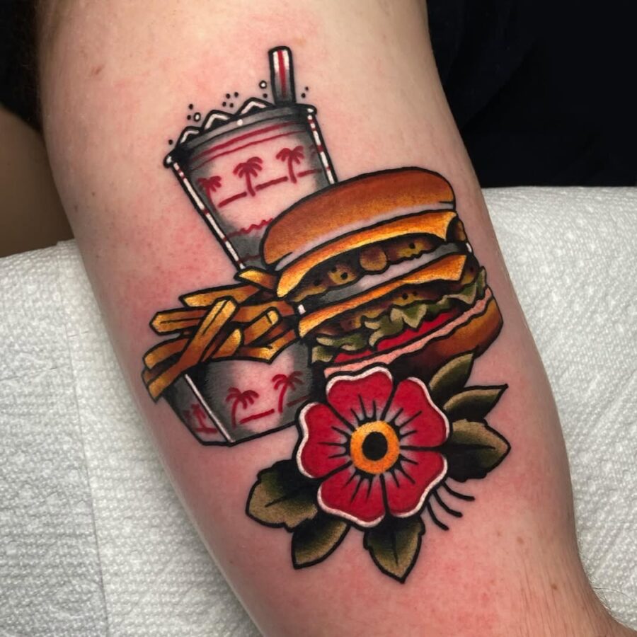 Vibrant burger tattoo with fries and drink