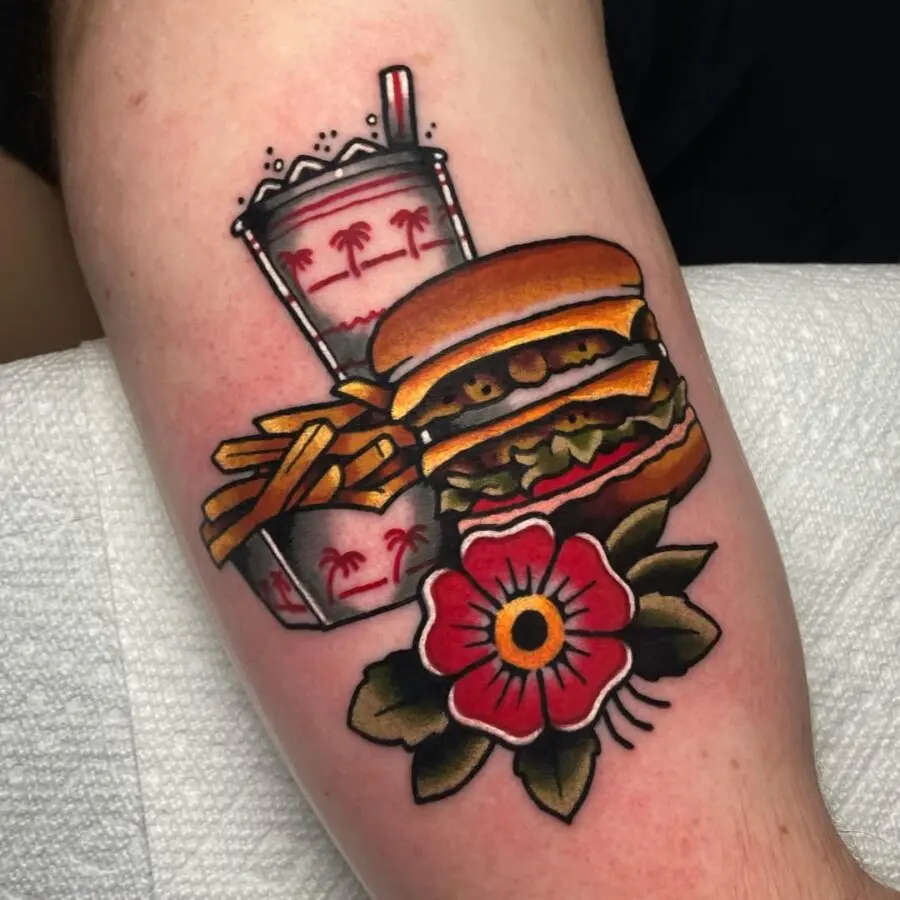 Vibrant burger tattoo with fries and drink