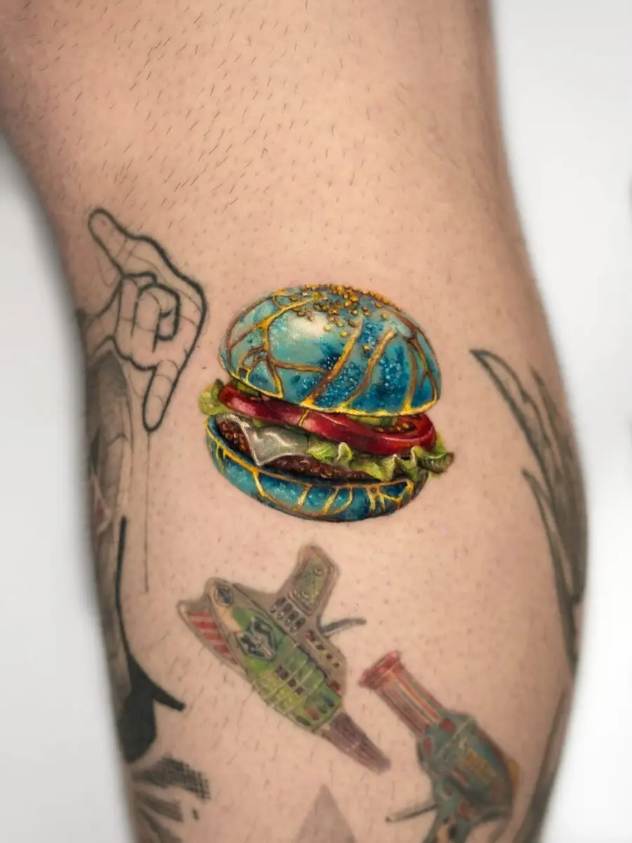 Vibrant burger tattoo with a pop of color