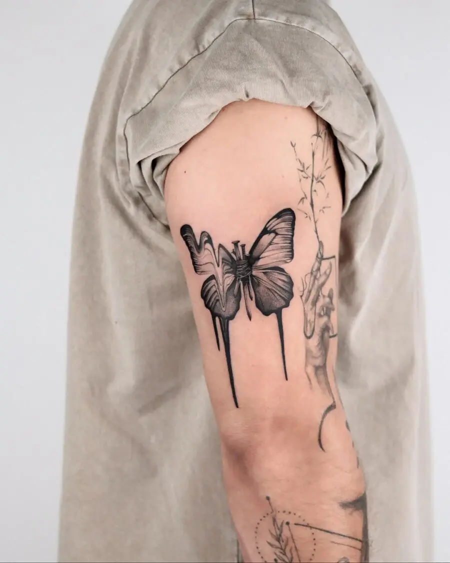 Stunning butterfly tattoo with artistic drips