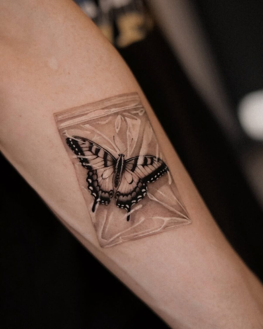 Intricate butterfly tattoo in a bag design