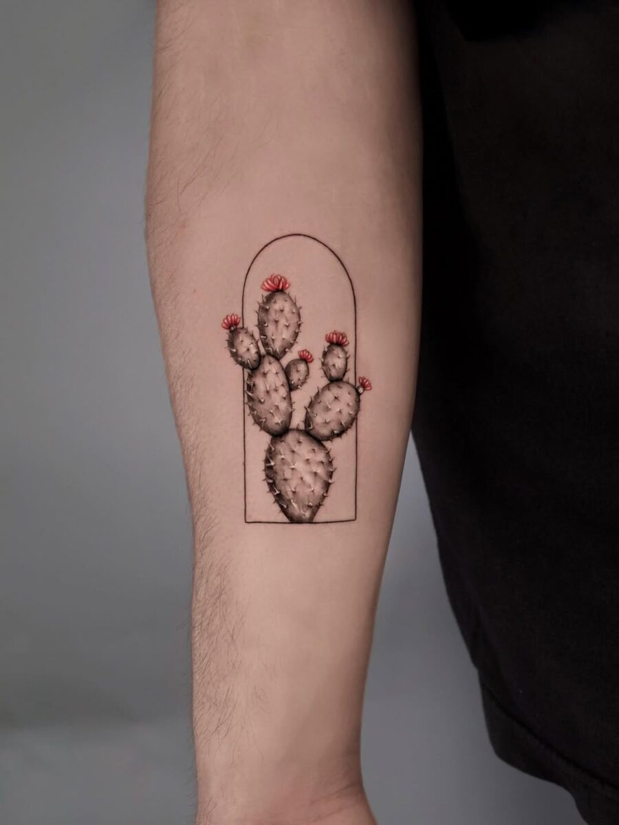 Vibrant cactus tattoo with floral accents