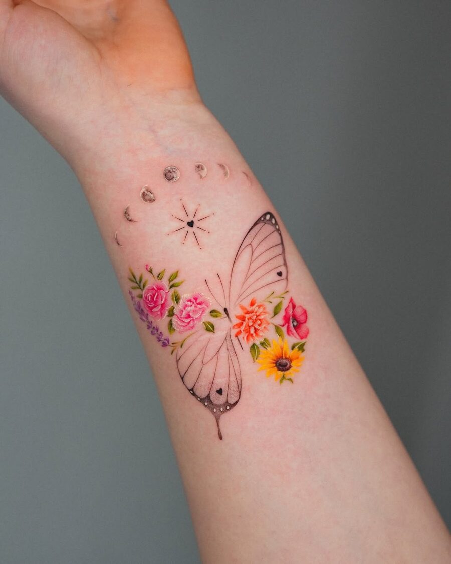 Delicate butterfly tattoo surrounded by floral elements
