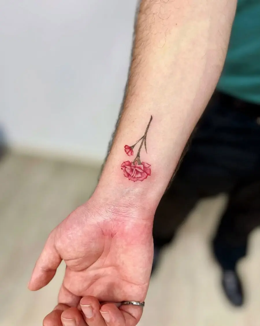 Vibrant carnation tattoo showcasing delicate details